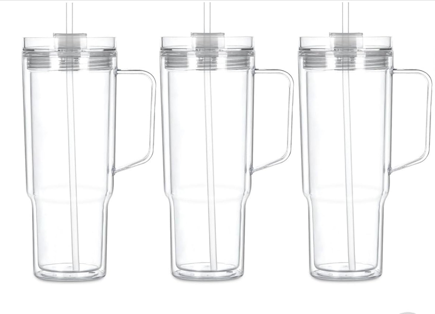 Clear snow globe tumbler with handle, straw, and lid. 