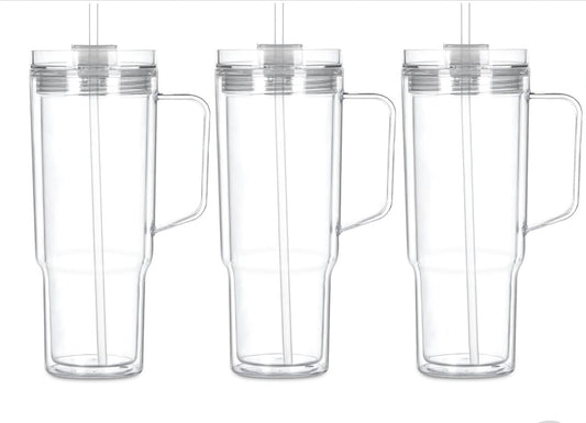 Clear snow globe tumbler with handle, straw, and lid. 